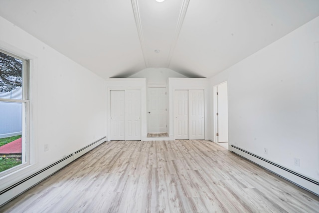 138 Greene Ave, Port Jefferson Station, NY 11776 - additional living space with a baseboard radiator, wood finished floors, vaulted ceiling, and healthy amount of natural light