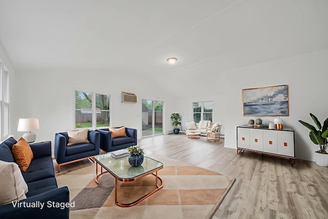 138 Greene Ave, Port Jefferson Station, NY 11776 - living room featuring wood finished floors, plenty of natural light, and vaulted ceiling