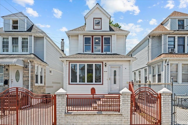 11148 128th St, South Ozone Park, NY 11420 - traditional style home featuring a gate, a fenced front yard, entry steps, and roof with shingles