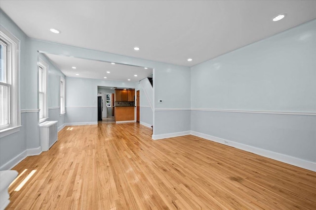 11148 128th St, South Ozone Park, NY 11420 - unfurnished living room featuring baseboards, light wood-style floors, and recessed lighting