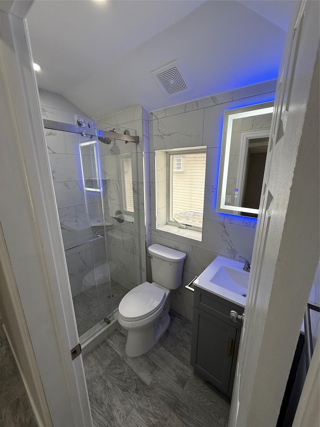 10917 124th St, South Ozone Park, NY 11420 - bathroom featuring toilet, vanity, a shower stall, lofted ceiling, and tile walls