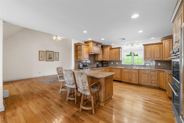 16 Hidden View Dr, Newburgh, NY 12550 - kitchen with a peninsula, open shelves, light wood finished floors, a kitchen bar, and light stone countertops
