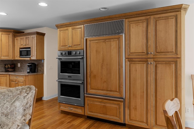 16 Hidden View Dr, Newburgh, NY 12550 - kitchen with appliances with stainless steel finishes, light wood finished floors, light stone counters, decorative backsplash, and recessed lighting