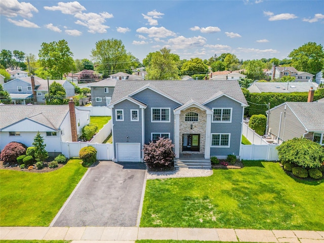 20 Frederick Dr, Plainview, NY 11803 - view of front of home with a gate, asphalt driveway, a residential view, and an attached garage