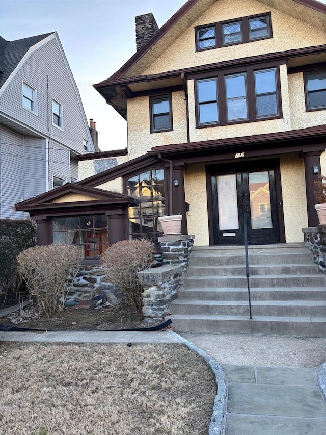 142 Cottage Ave, Mount Vernon, NY 10550 - view of front of home featuring french doors, stucco siding, and a chimney