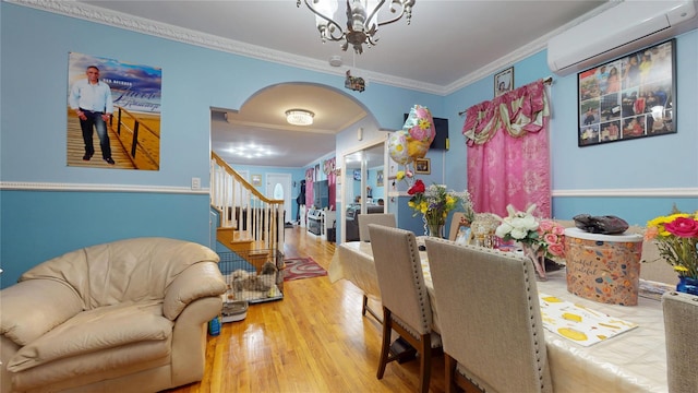10920 116th St, South Ozone Park, NY 11420 - dining area featuring arched walkways, a wall unit AC, a chandelier, ornamental molding, and stairway