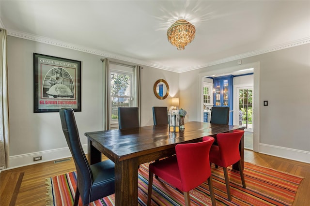 225 Fisher Ave, White Plains, NY 10606 - dining room with a chandelier, wood finished floors, and crown molding