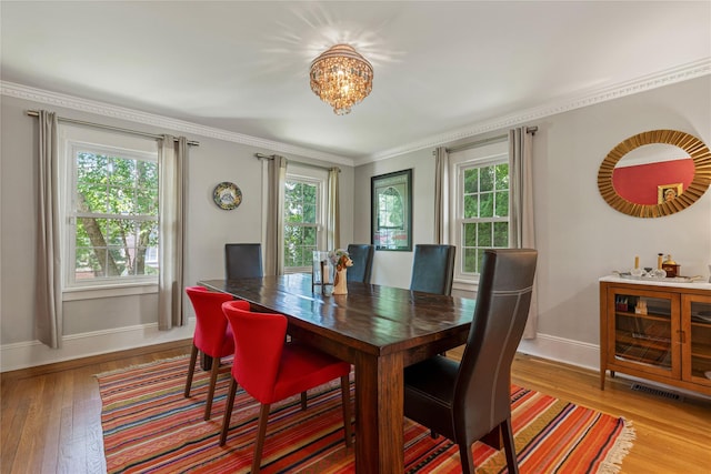 225 Fisher Ave, White Plains, NY 10606 - dining room featuring plenty of natural light, wood-type flooring, a chandelier, and ornamental molding