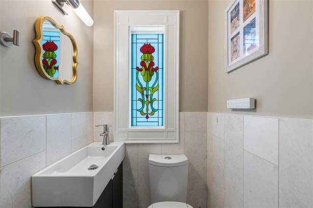 225 Fisher Ave, White Plains, NY 10606 - bathroom with tile walls, vanity, and a wainscoted wall