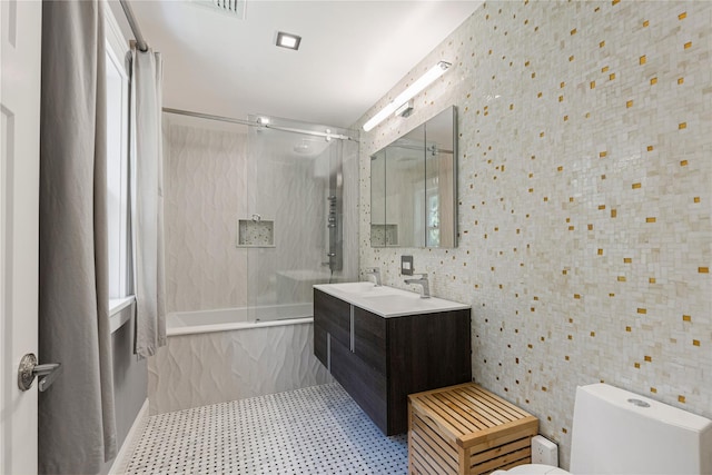 225 Fisher Ave, White Plains, NY 10606 - bathroom with tiled shower / bath combo, vanity, and tile patterned floors
