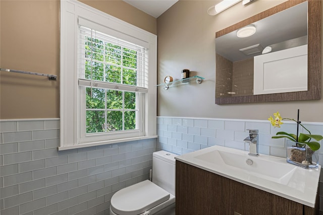 225 Fisher Ave, White Plains, NY 10606 - bathroom with tile walls, vanity, healthy amount of natural light, and a wainscoted wall
