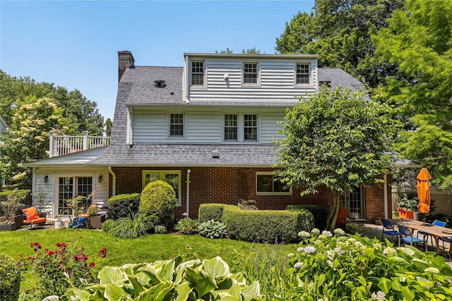 225 Fisher Ave, White Plains, NY 10606 - back of property featuring a chimney, brick siding, a patio, and a shingled roof