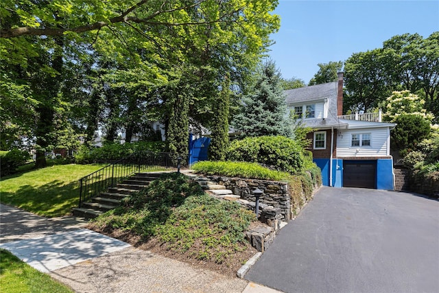225 Fisher Ave, White Plains, NY 10606 - view of front of property featuring driveway, an attached garage, a chimney, and a balcony
