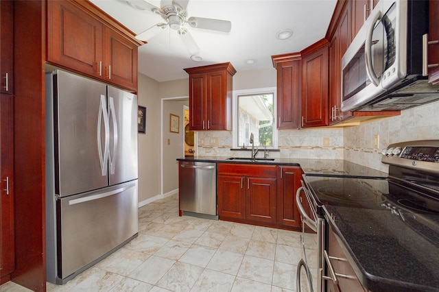 18 Lorraine Blvd, Poughkeepsie, NY 12603 - kitchen featuring stainless steel appliances, a sink, reddish brown cabinets, ceiling fan, and backsplash