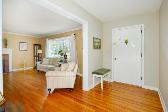 18 Lorraine Blvd, Poughkeepsie, NY 12603 - foyer featuring light wood finished floors, baseboards, ornamental molding, and a brick fireplace