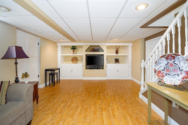 18 Lorraine Blvd, Poughkeepsie, NY 12603 - living room with built in features, baseboards, light wood-style flooring, stairs, and a drop ceiling