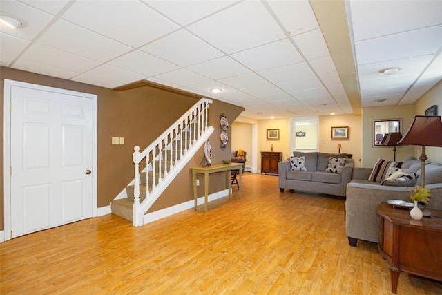 18 Lorraine Blvd, Poughkeepsie, NY 12603 - living area with a paneled ceiling, light wood-style floors, stairway, and baseboards