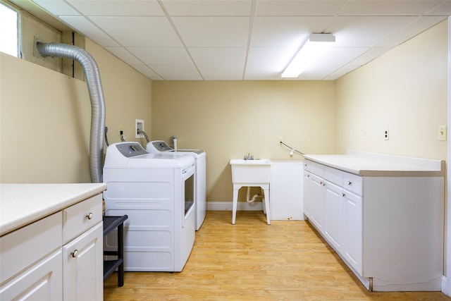 18 Lorraine Blvd, Poughkeepsie, NY 12603 - laundry room with cabinet space, separate washer and dryer, and light wood-style flooring