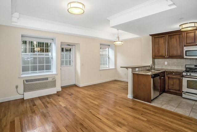 150-31 12th Ave Unit 112, Whitestone, NY 11357 - kitchen featuring stainless steel appliances, tasteful backsplash, ornamental molding, an AC wall unit, and stone counters
