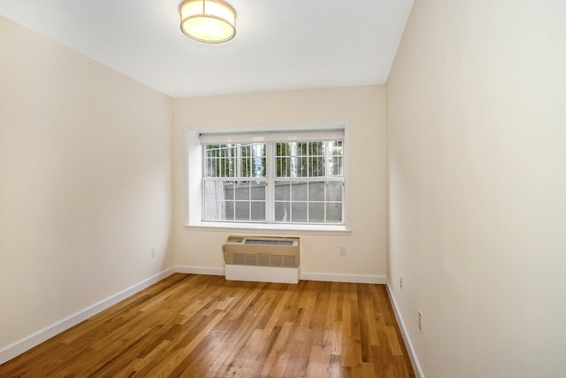 150-31 12th Ave Unit 112, Whitestone, NY 11357 - empty room with wood finished floors and a wall mounted AC