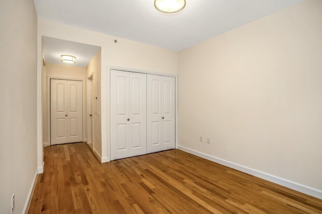 150-31 12th Ave Unit 112, Whitestone, NY 11357 - unfurnished bedroom with wood finished floors and a closet