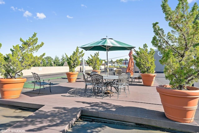 150-31 12th Ave Unit 112, Whitestone, NY 11357 - view of patio / terrace with outdoor dining area and a wooden deck