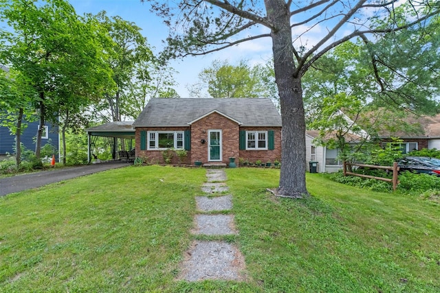5 Fairview Ave, New Paltz, NY 12561 - view of front of property featuring driveway, a carport, a front lawn, and brick siding