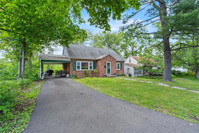 5 Fairview Ave, New Paltz, NY 12561 - view of front of home featuring brick siding, a front yard, asphalt driveway, and an attached carport