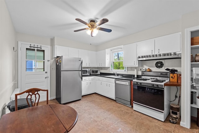 5 Fairview Ave, New Paltz, NY 12561 - kitchen featuring freestanding refrigerator, dishwashing machine, gas stove, a sink, and dark countertops