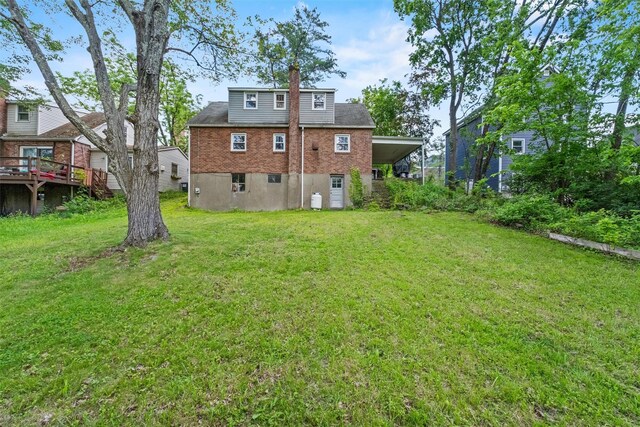 5 Fairview Ave, New Paltz, NY 12561 - rear view of house featuring a chimney, a yard, and an attached carport