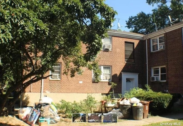 160-20 76th Ave, Fresh Meadows, NY 11366 - rear view of property featuring brick siding and cooling unit