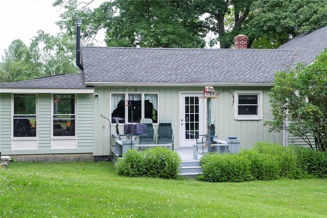 184 Sawchuck Rd, Millerton, NY 12546 - rear view of house featuring a lawn, a chimney, roof with shingles, and board and batten siding