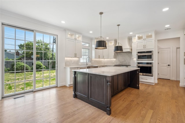 7 Eton Pl, Plainview, NY 11803 - kitchen with stainless steel double oven, white cabinets, tasteful backsplash, and recessed lighting
