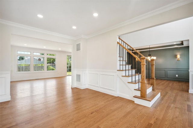 7 Eton Pl, Plainview, NY 11803 - staircase with a decorative wall, a chandelier, recessed lighting, wood finished floors, and crown molding