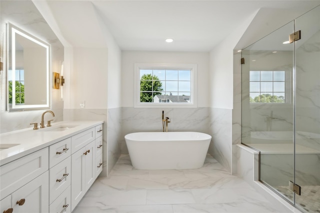 7 Eton Pl, Plainview, NY 11803 - full bathroom with double vanity, marble finish flooring, a freestanding bath, a wainscoted wall, and a marble finish shower