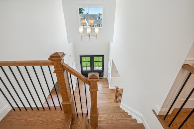 7 Eton Pl, Plainview, NY 11803 - stairway featuring a chandelier, wood finished floors, baseboards, and a high ceiling