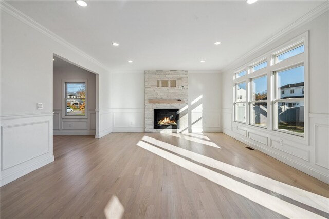 7 Eton Pl, Plainview, NY 11803 - unfurnished living room featuring ornamental molding, a fireplace, light wood-type flooring, recessed lighting, and a decorative wall