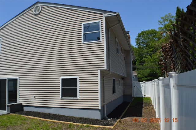 294 Fir Grove Rd, Ronkonkoma, NY 11779 - view of side of home with a gate and a chimney
