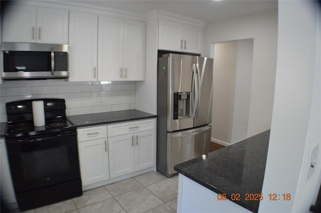 294 Fir Grove Rd, Ronkonkoma, NY 11779 - kitchen with stainless steel appliances, tasteful backsplash, white cabinetry, light tile patterned floors, and dark stone countertops