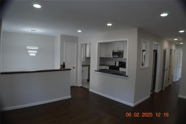 294 Fir Grove Rd, Ronkonkoma, NY 11779 - kitchen with appliances with stainless steel finishes, dark countertops, dark wood-type flooring, recessed lighting, and baseboards