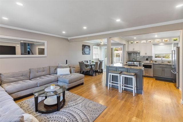 22 Martha St, Freeport, NY 11520 - living room with plenty of natural light, light wood-style flooring, recessed lighting, and ornamental molding