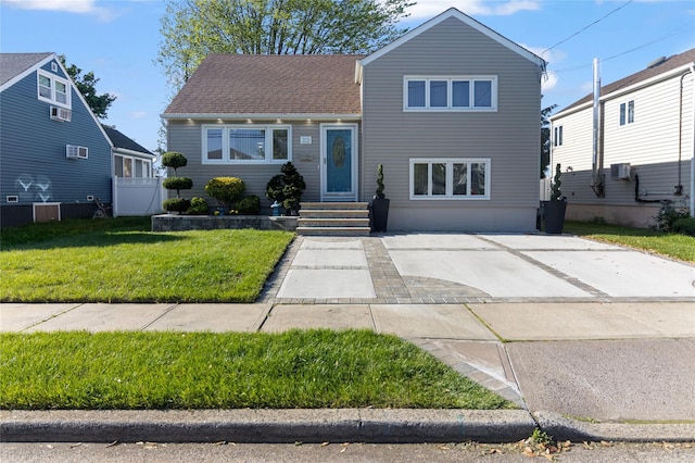 22 Martha St, Freeport, NY 11520 - tri-level home featuring a front lawn and roof with shingles