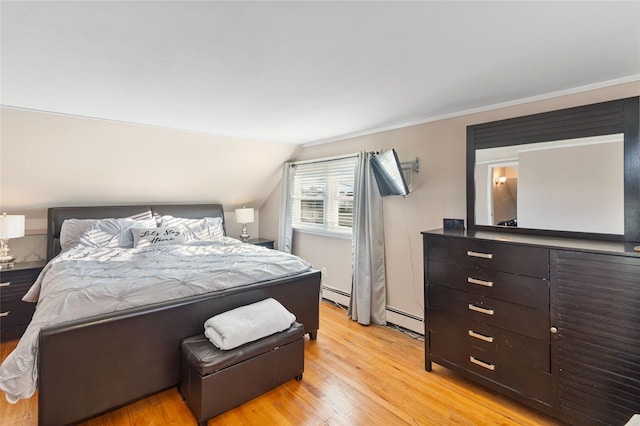 22 Martha St, Freeport, NY 11520 - bedroom featuring light wood-type flooring, vaulted ceiling, and baseboard heating