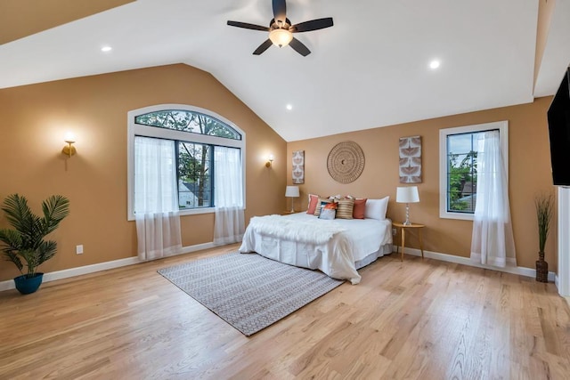 22 Elderberry Ln, Valley Stream, NY 11581 - bedroom featuring multiple windows, vaulted ceiling, light wood finished floors, baseboards, and ceiling fan