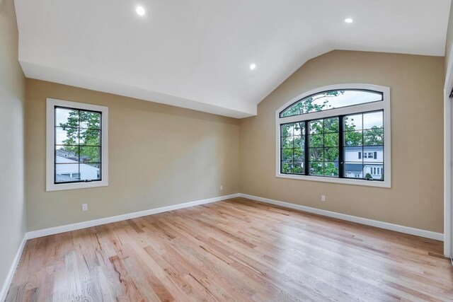 22 Elderberry Ln, Valley Stream, NY 11581 - empty room with plenty of natural light, vaulted ceiling, light wood finished floors, recessed lighting, and baseboards
