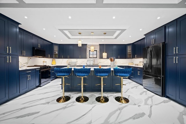 22 Elderberry Ln, Valley Stream, NY 11581 - kitchen featuring black appliances, a tray ceiling, blue cabinets, glass insert cabinets, and recessed lighting
