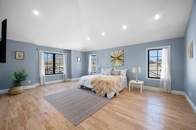 22 Elderberry Ln, Valley Stream, NY 11581 - bedroom with light wood-style flooring, baseboards, recessed lighting, and high vaulted ceiling