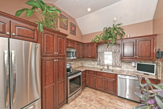29 Andrew Ln, Levittown, NY 11756 - kitchen featuring stainless steel appliances, lofted ceiling, tasteful backsplash, a sink, and light stone counters