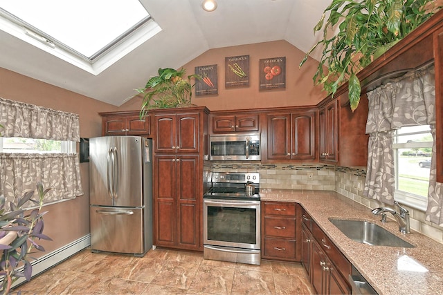 29 Andrew Ln, Levittown, NY 11756 - kitchen with stainless steel appliances, a sink, vaulted ceiling, light stone counters, and a baseboard heating unit