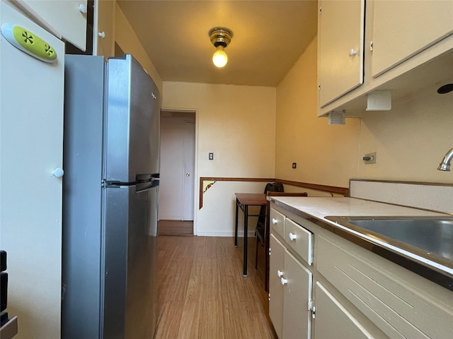 1480 Thieriot Ave Unit 6O, Bronx, NY 10460 - kitchen with freestanding refrigerator, light wood-style flooring, and white cabinets